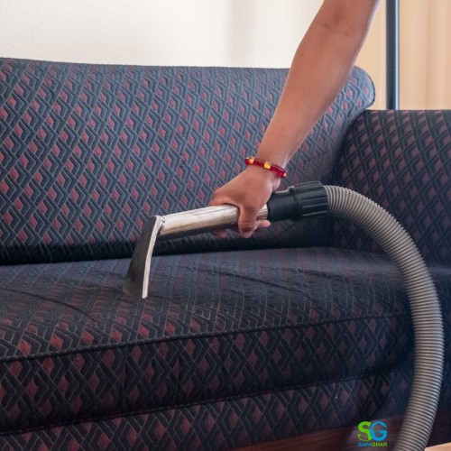 a woman cleaning sofa
